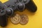 Crypto gaming concept. Video game controller with a bitcoin cryptocurrency coin