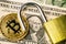 Cryptocurrency bitcoin coin near one dollar banknote and opened padlock. Symbol of crypto currency - electronic virtual money for