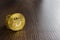 Cryptocurrency. Bitcoin virtual money. Golden coin on wooden table