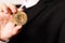 Cryptocurrency Bitcoin. Women hold the cryptocurrency coin on hand. Physical bitcoins gold coin