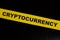 Cryptocurrency caution, warning and danger concept. Yellow barricade tape with word in dark black background.