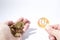 Cryptocurrency hand is holding euro coins and a primecoin compos