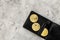 Cryptocurrency physical golden bitcoin coins for changing or selling stone background top view mock up