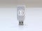 Cryptocurrency private key with glowing Bitcoin logo - USB Flash drive on white surface