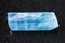 crystal of aquamarine (blue beryl) gem on dark