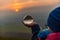 Crystal ball in girl`s hand during sunset