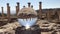 Crystal ball reflection against ancient ruins of roman city, columns, hand holding