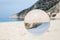 Crystal ball on sandy greek beach