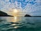 Crystal Beach - View of the sun and the clouds on the sky with the sea water beneath from the Famous Crystal Beach of Nusa Penida