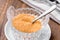 Crystal bowl with brown cane  sugar macro shallow focus on wooden table