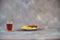 Crystal brandy glass and plate with chocolate and lemon slices on a gray background