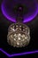 Crystal chandelier on black and purple background