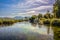 Crystal clear, aquarium like water stream under blue sky with scattered clouds