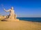 Crystal clear azure water with white beach and palms - paradise coastline. Statue of the god Poseidon. coastline of Hurghada, Red