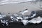 Crystal Clear and Blue Ice Floes on a Black Sand Beach on the Iceland Coast