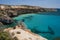 Crystal clear waters of Tsigrado beach at Milos island in Greece