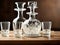 Crystal decanter and shot glasses on a wooden table.