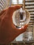 Crystal glass lensball over dirty square spiral staircase in old hospital