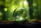 Crystal glass sphere with green tree inside on light green forest background. Generative AI