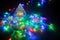 crystal glowing Christmas tree surrounded by shining garland in dark. concept new year and christmas