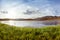 Crystal lake and grass on the montains backgroud. Altay