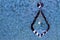 Crystal Teardrop Pendant, Hanging Against Blue Background