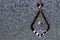 Crystal Teardrop Pendant, Hanging Against Mottled Background