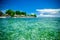 Crystal water and beach with bungalows in the background Sumatra, Indonesia