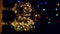 Crystal wine glasses decorated with golden glowing garland New Year Christmas table bokeh lights background vertical 4K.