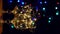 Crystal wine glasses decorated with golden glowing garland New Year Christmas table bokeh lights background vertical 4K.