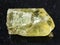 crystal of yellow apatite gemstone on dark