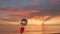 Crystall ball set on the mouth of a red wine glass with a sea and beautiful sky at sunset background.