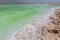 Crystallized salt cover the beach of Dead Sea in Israel