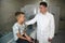 CT scanner with patient and doctor. Doctors examine the child on a tomograph.