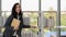 Cuacasian female university students standing at bookshelf seaching and reading book in library