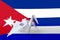 Cuba flag depicted on paper origami crane wing. Handmade arts concept