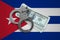 Cuba flag with handcuffs and a bundle of dollars. Currency corruption in the country. Financial crimes