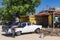 Cuban man wash his american black white 1957 Ford Fairlane classic car in Varadero Cuba -