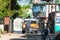 A cuban man washing an american brown 1955 Desoto classic car with white roof in a