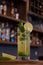 Cuban mojito drink with lemon mint and good herb on a wooden base with a bar background