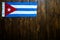 Cuban national flag on wooden table.