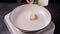 Cube of butter melting in pan, preparation for cooking.