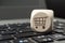 Cube dice on a keyboard with a cart, online shopping