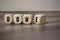 Cube and dice with word done and green checkmark on wooden background