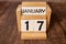 Cube shape calendar for January 17 on wooden surface with empty space for text,