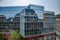 Cube shape rooftop of modern corporate building with mirrored glass wall and windows