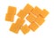 Cubed mild cheddar cheese on a white background