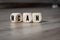 Cubes, blocks or dice with man can on wooden background