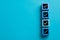 Cubes with check marks on light blue background, top view. Space for text