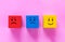 Cubes with cute faces depicting human emotions: anger, sadness and happiness